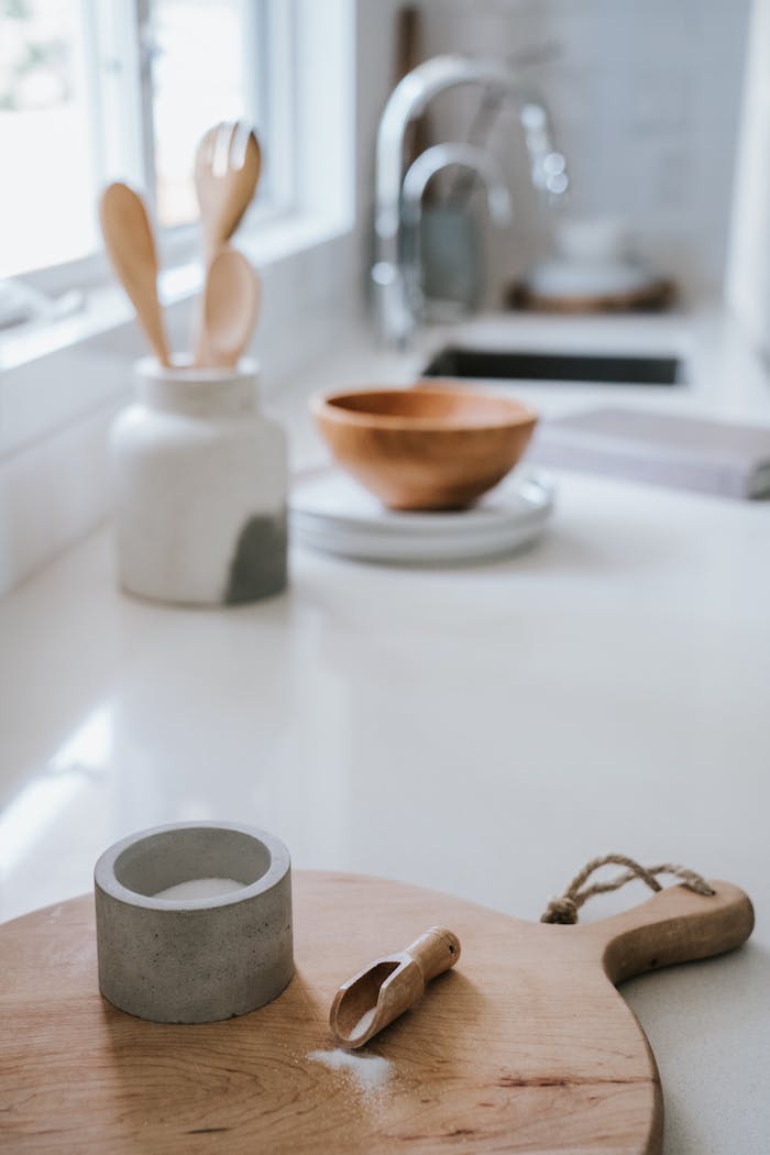 A serene Japandi-style kitchen featuring a wooden chopping board and modern utensils.